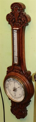 Lot 1428 - ^ An oak cased carved aneroid barometer retailed by A. Franks Optician, Manchester