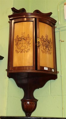 Lot 1430 - A late 19th/early 20th century mahogany bow fronted hanging corner cupboard, the doors...