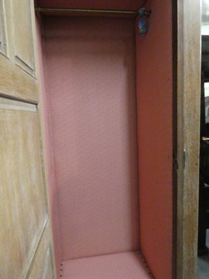 Lot 1434 - An Arts & Crafts Limed Oak Wardrobe, designed by Frederick Muntzer, three-door two-sectional...