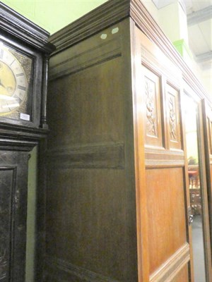 Lot 1434 - An Arts & Crafts Limed Oak Wardrobe, designed by Frederick Muntzer, three-door two-sectional...