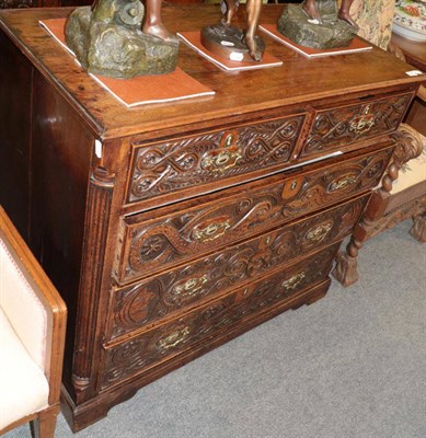 Lot 1447 - A George III oak and later carved five drawer straight fronted chest, with fluted columns,...