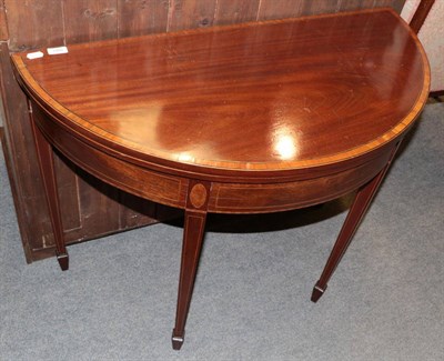 Lot 1450 - ^ A George III mahogany and satinwood banded foldover card table, on square tapering legs, 96cm...