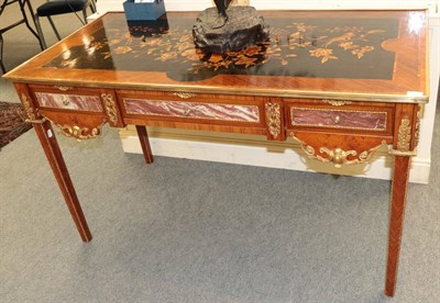 Lot 1461 - A 20th century bureau plat with gilt metal mounts, 141cm wide