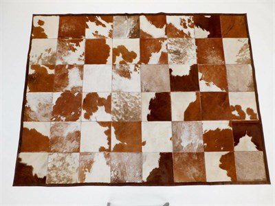 Lot 181 - Hides/Skins: A Large Patchwork Cow Hide Rug, modern, constructed with square sections of cow...
