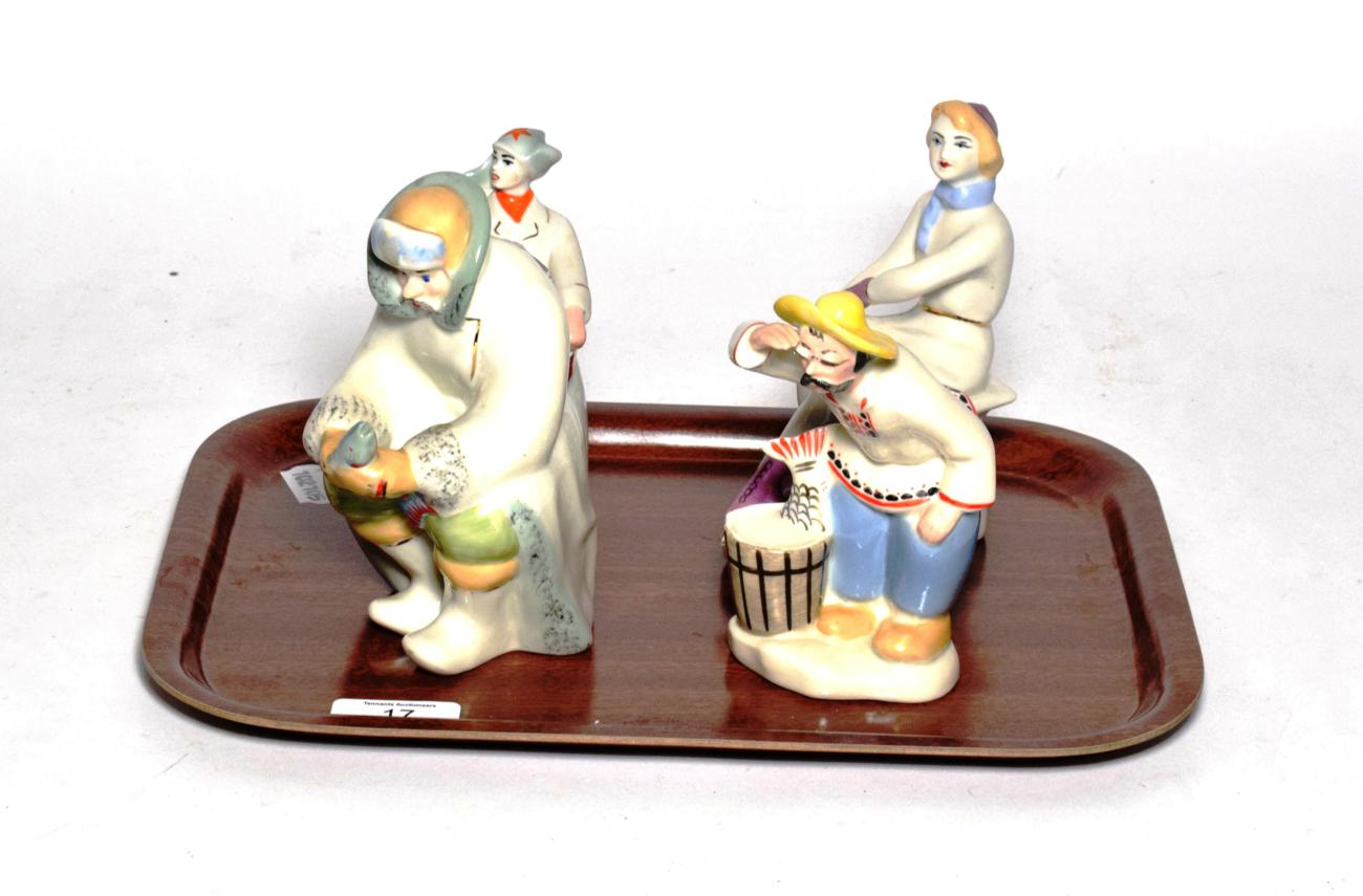 Lot 17 - Four 20th century Russian figures including two fishermen, skater and drummer