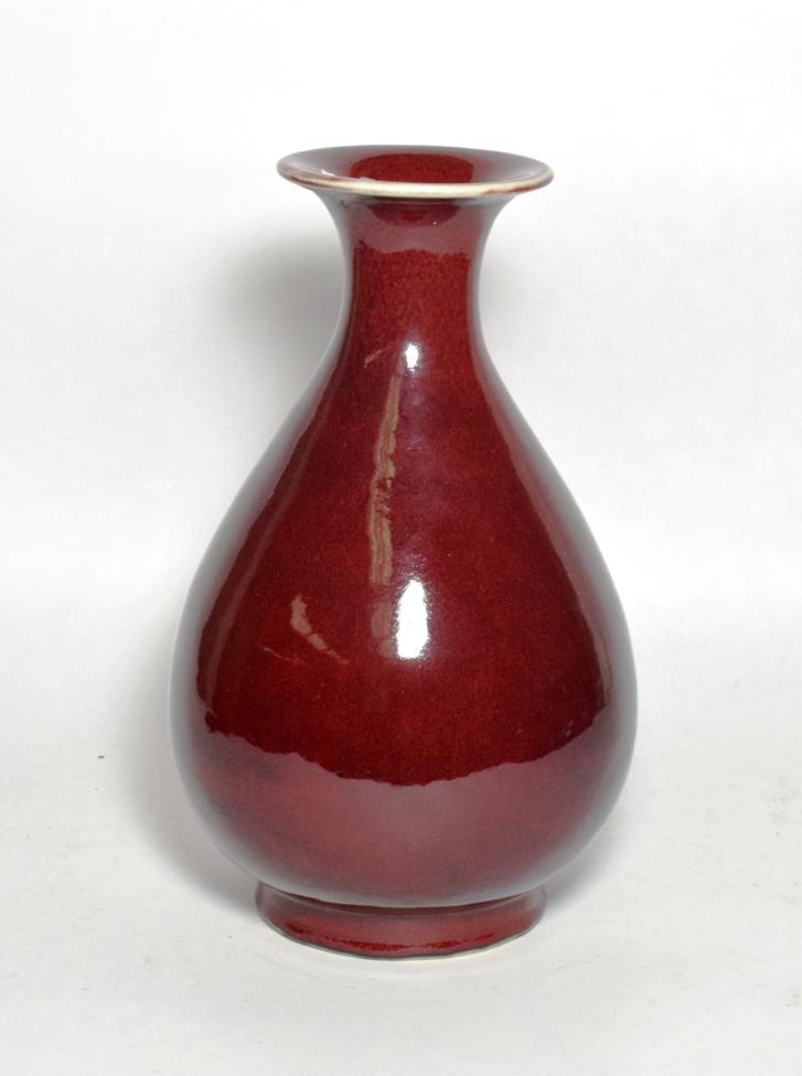 Lot 38 - A Chinese sang de boeuf, baluster vase with everted rim