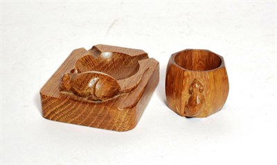 Lot 60 - A Robert 'Mouseman' Thomspon oak ashtray and a similar napkin ring, each carved with mouse...