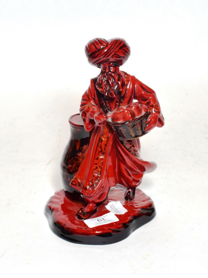 Lot 61 - A Royal Doulton flambe figure 'The Lamp Seller' HN 3278