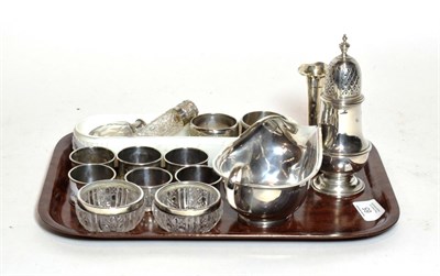 Lot 65 - A group of silver, including: a sauceboat, Sheffield, 1943; a George III-style caster, London,...