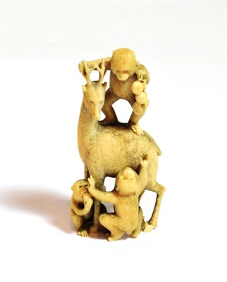 Lot 76 - A Japanese ivory okimono group, Meiji period (1868-1912) carved as three monkeys climbing a deer to