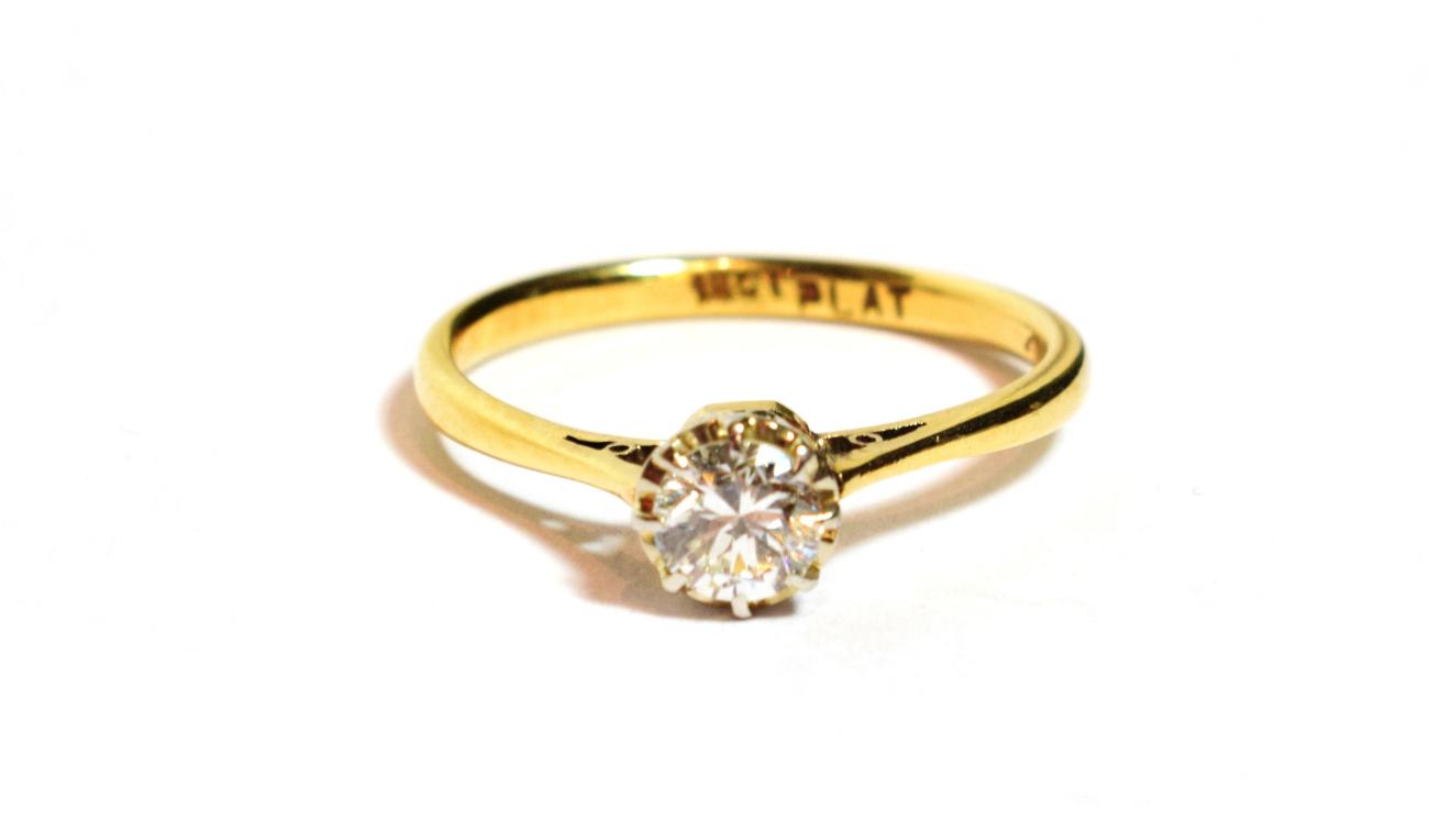Lot 86 - A solitaire diamond ring, a round brilliant cut diamond in a claw setting above an extended...
