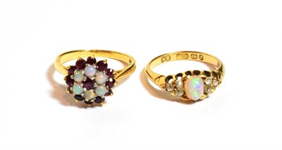 Lot 87 - An 18 carat gold opal and diamond ring, finger size K1/2; and a garnet and opal cluster ring,...