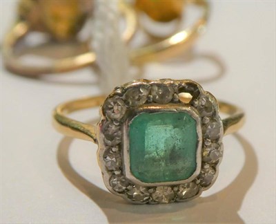 Lot 93 - An emerald and diamond cluster ring, stamped '18CT', finger size M1/2 (one stone deficient); a jade