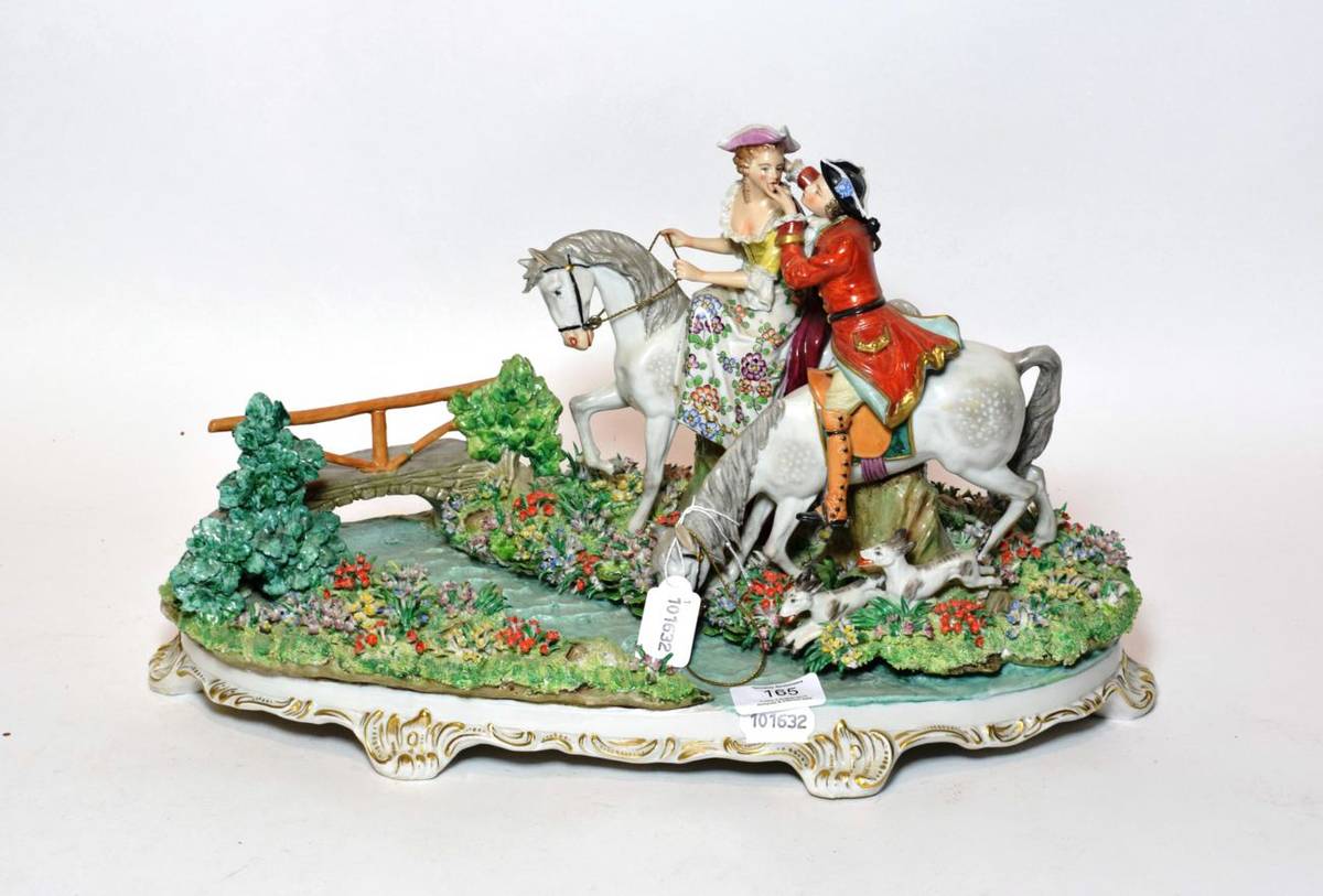 Lot 165 - A Sitzendorf figural hunting group, 20th century, lady and beau on horseback, accompanied by hounds