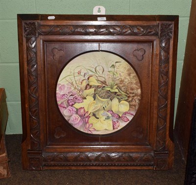 Lot 167 - A large Coalport floral platter in a heavy oak frame carved in the manner Pugin