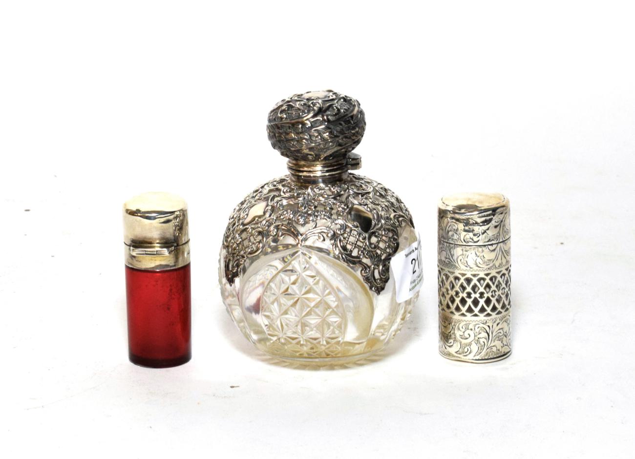Lot 211 - Two Victorian silver scent-bottles, comprising: a globular example, with openwork silver-mounts, by