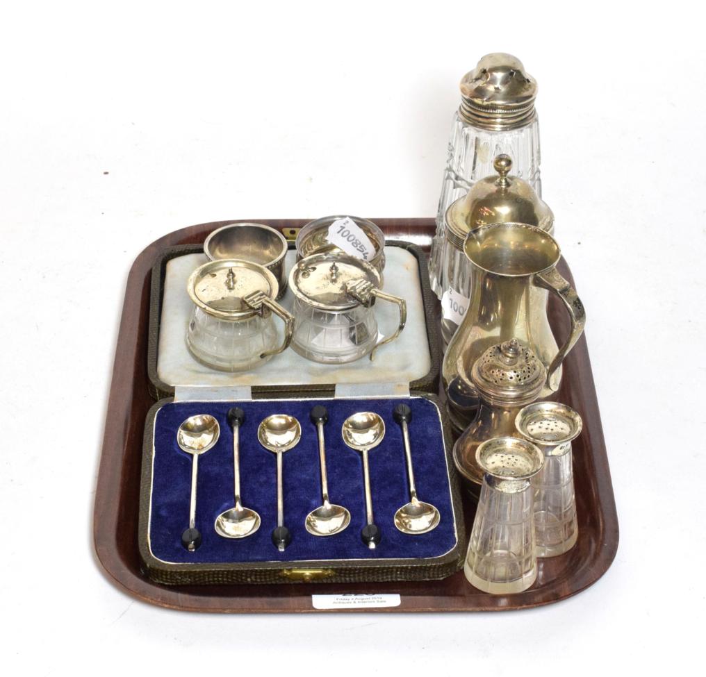 Lot 226 - A Georgian silver pepperette, set of coffee bean spoons, four piece etched cased set, sugar shaker