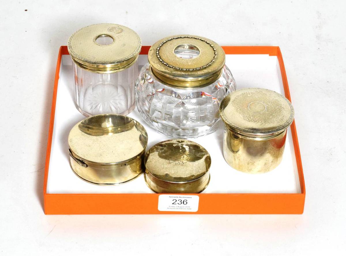 Lot 236 - Five silver or silver-mounted dressing table-jars, comprising: three circular silver examples,...