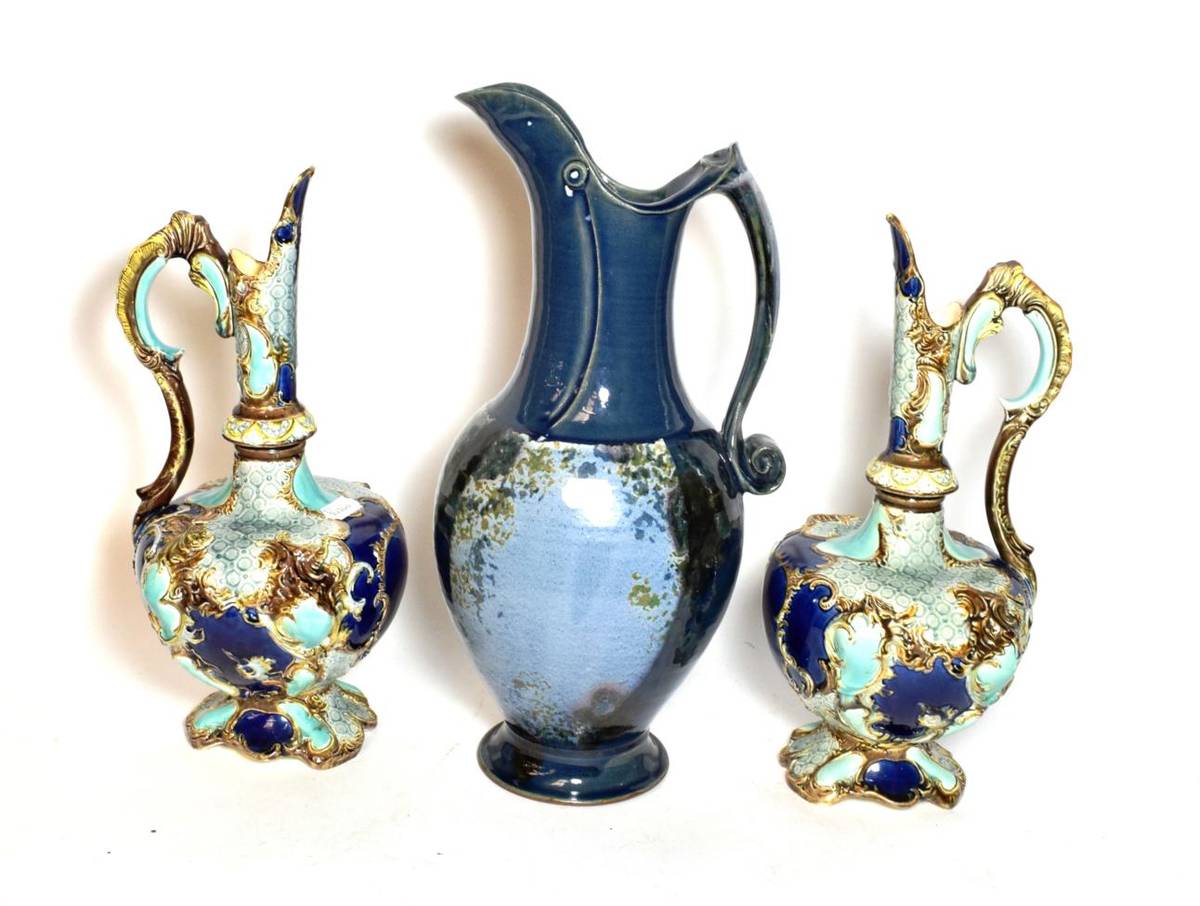 Lot 253 - A pair of Victorian painted pottery ewers together with a studio pottery example with a blue...