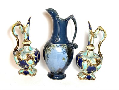 Lot 253 - A pair of Victorian painted pottery ewers together with a studio pottery example with a blue...