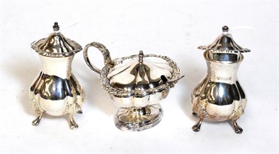 Lot 257 - An Elizabeth II silver three-piece condiment-set,comprising: a mustard-pot by Roberts and Belk,...