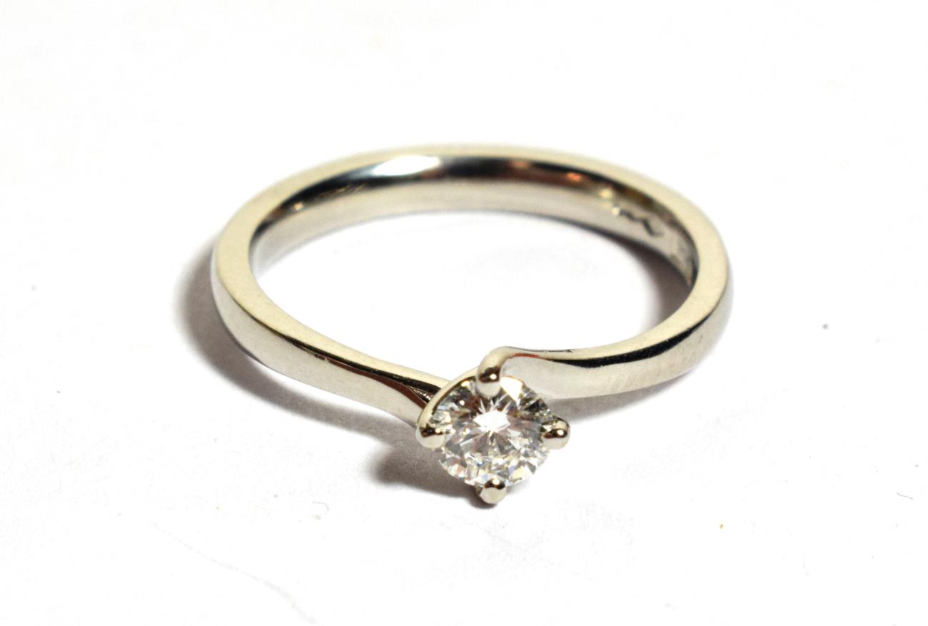 Lot 268 - A platinum solitaire diamond ring, a round brilliant cut diamond in a claw setting, to bypass...