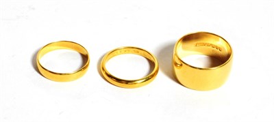 Lot 287 - Three 22 carat gold band rings, finger sizes J1/2, J1/2 and M