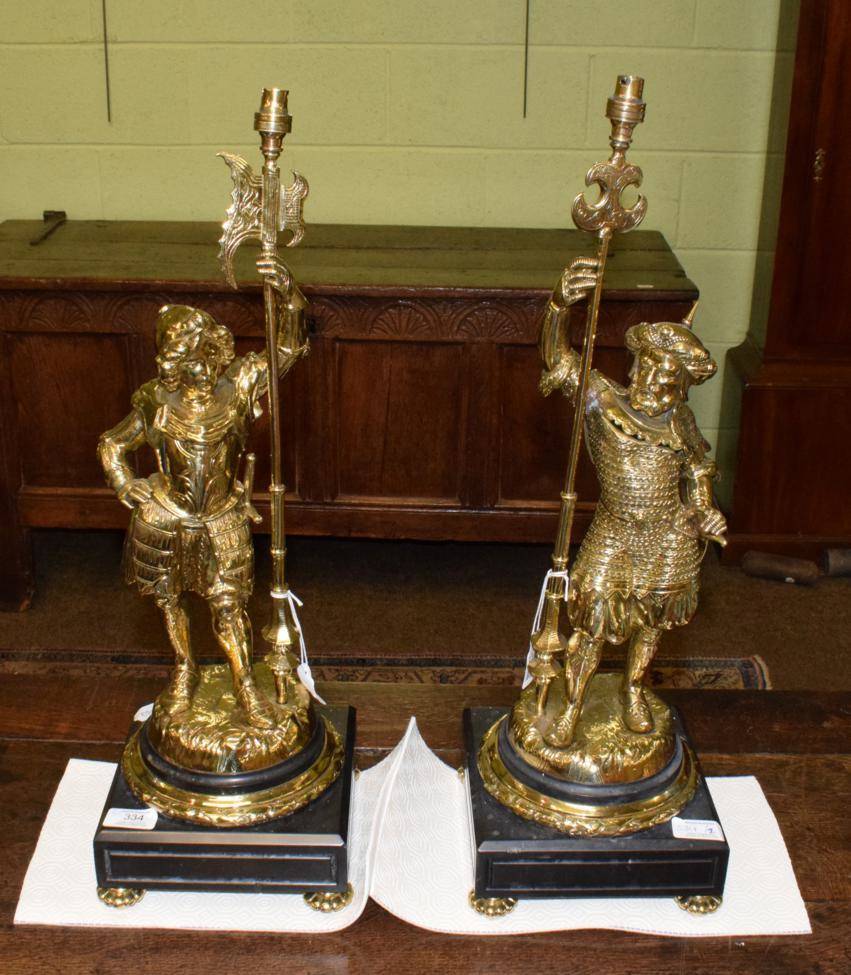 Lot 334 - A pair of gilt brass figural lamp bases, 20th century, modelled as a Renaissance soldier and a...