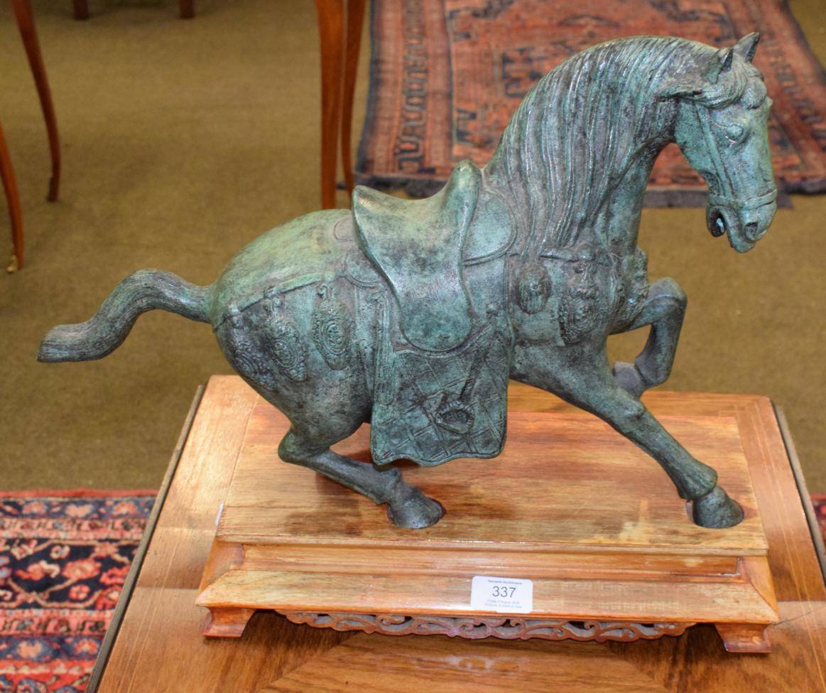Lot 337 - A bronze Tang style horse on wooden stand