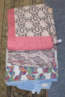 Lot 1078 - Pink and black paisley quilt with pink trim; another similar; and a blue and white cotton quilt...