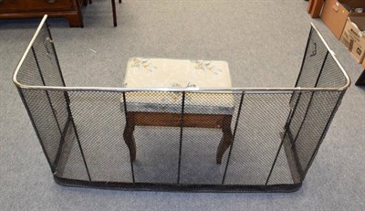 Lot 1197 - A 19th century polished steel and wirework fire guard; together with a piano stool