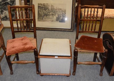 Lot 1204 - A pair of 19th century elm spindle back rush seated chairs; and a part upholstered box stool (3)