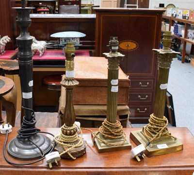 Lot 1208 - Two Corinthian columnar brass table lamps, a plated table lamp and a composition table lamp (4)