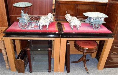Lot 1217 - A pair of part ebonised modern display tables, each mounted with a metal and plaster model of...