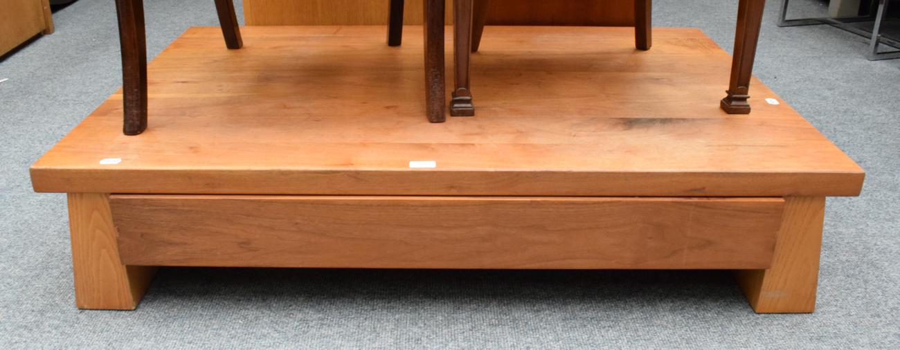 Lot 1222 - A solid wood coffee table with drawer