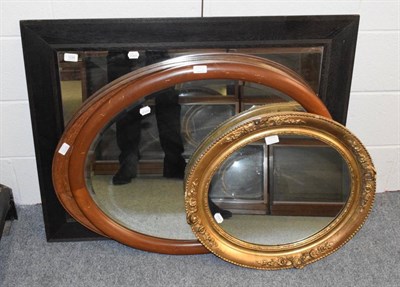 Lot 1235 - A circular gilt framed mirror; two oval mirrors; and an ebonised rectangular mirror (4)