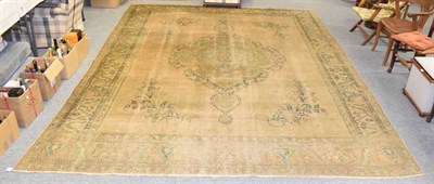 Lot 1241 - North West Iranian carpet, the field centred by a floral medallion within meandering vine...