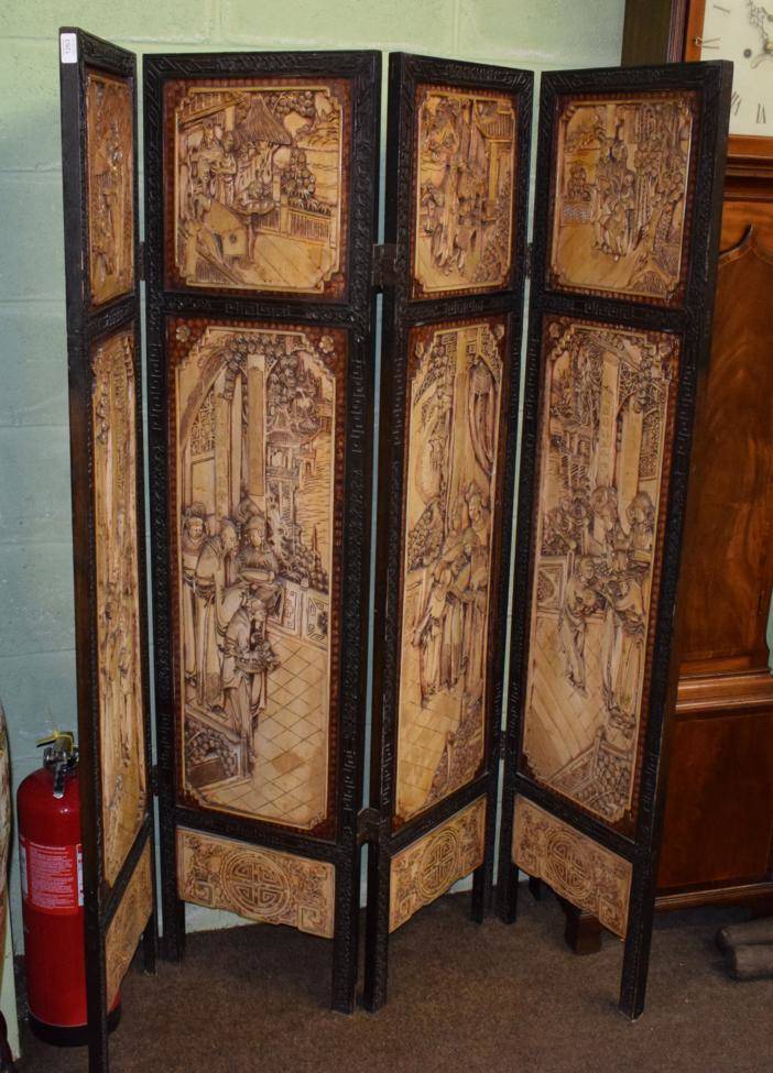 Lot 1263 - A 20th century Chinese heavily carved four-fold screen