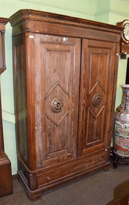 Lot 1265 - A continental pitch pine armoire fitted with a base drawer