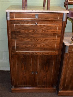 Lot 1270 - A 1970's rosewood secretaire cabinet, with grey marble top above a long drawer and fall front...