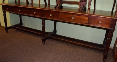 Lot 1272 - A large late 19th century serving table with fitted drawers, raised on turned tapering legs, joined
