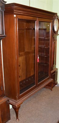 Lot 1278 - An early 20th century mahogany glazed gun cabinet, a bold cornice enclosing small shelves with...