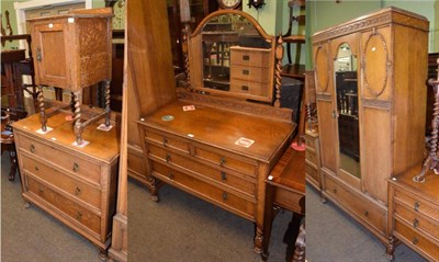 Lot 1290 - An early 20th century oak four piece bedroom suite, comprising wardrobe, dressing table, chest...