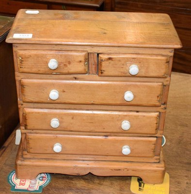 Lot 1313 - A Victorian miniature pine four-height chest of drawers