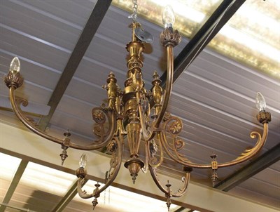 Lot 1317 - A gilt metal five-height chandelier with scroll cast arms