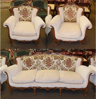 Lot 1336 - A reproduction Louis XV style walnut framed three-piece suite, upholstered in floral and cream...