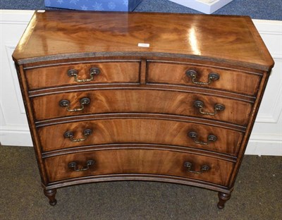 Lot 1342 - A reproduction crossbanded mahogany concave four height chest of drawers
