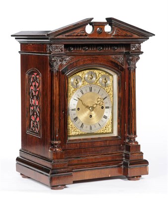 Lot 1380 - A Faux Rosewood Chiming Table Clock, circa 1890, the case with a broken arched top, Corinthian...