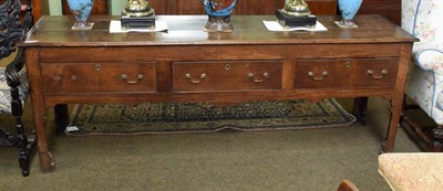 Lot 1360 - An early 18th century oak low dresser, the moulded top with three boards above three frieze...