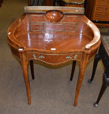 Lot 1368 - A reproduction French Kingwood writing table of unusual form, the shaped top with a conforming...